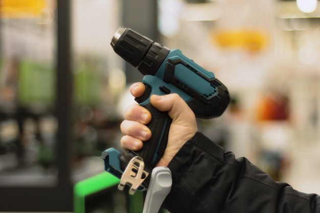 Man Holding Cordless Screwdriver